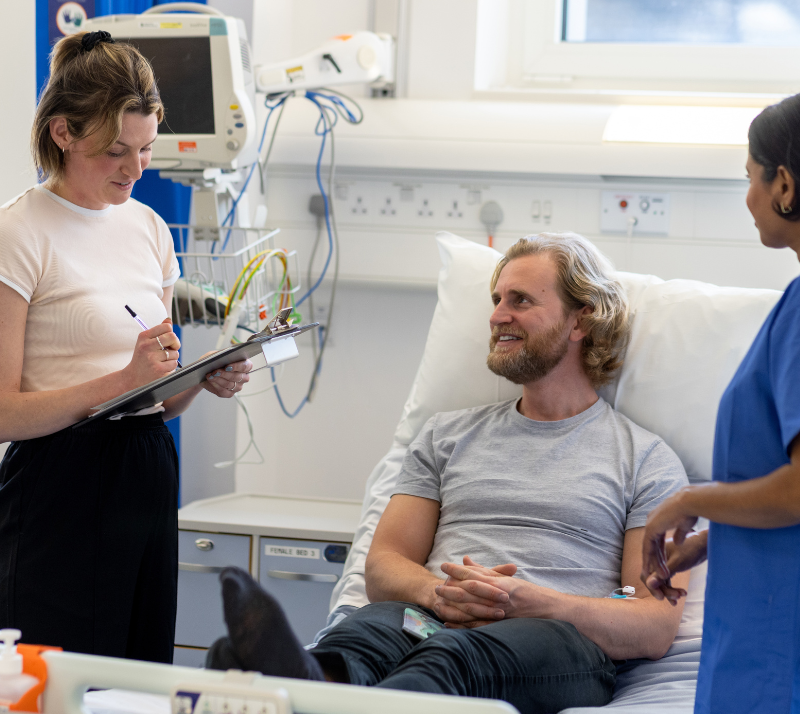Male patient talking with nurse in hospital
